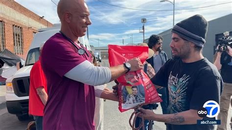 Kwane stewart - Kwane Stewart, known as “the Street Vet,’’ talks with Christina Crayton about the health of Pepper, leashed at left, in downtown Los Angeles. Kilo, a muscular gray pit bull, stood staunchly ...